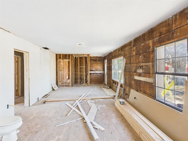 410 S Lowe Ave, Pauls Valley, OK 73075 - unfurnished living room featuring wood walls