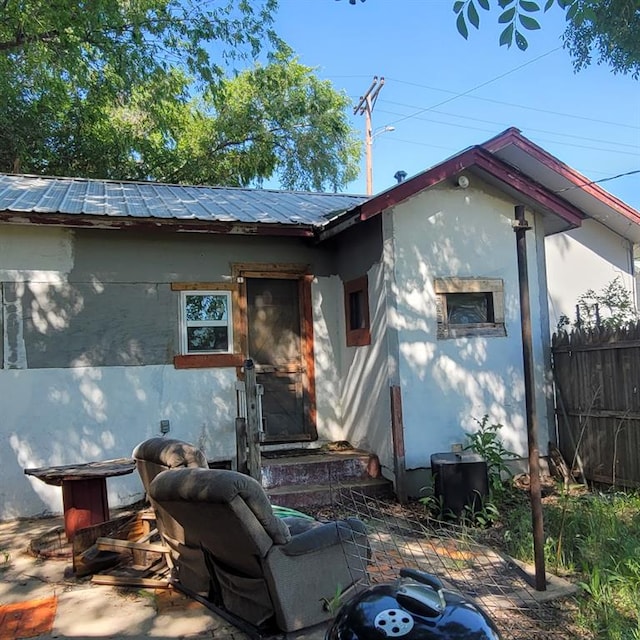 608 7th St, Woodward, OK 73801 - back of house featuring a patio area, a metal roof, entry steps, and stucco siding