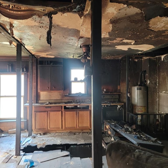 608 7th St, Woodward, OK 73801 - kitchen with water heater and brown cabinets