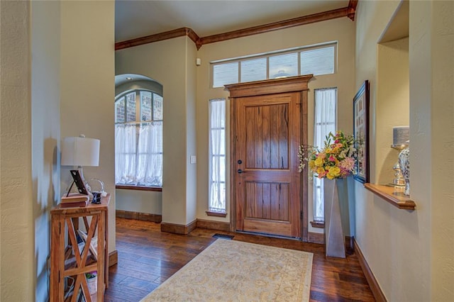 entryway featuring dark wood-style flooring and ornamental molding