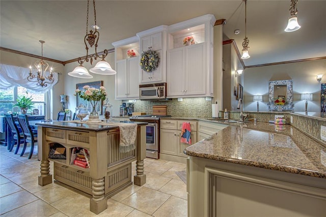 kitchen with appliances with stainless steel finishes, crown molding, open shelves, a chandelier, and tasteful backsplash