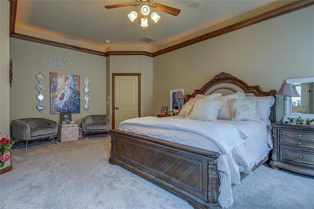 bedroom featuring carpet, ornamental molding, and a ceiling fan