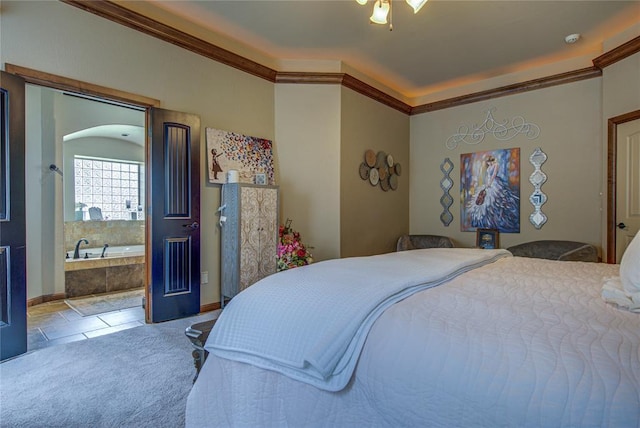 bedroom with ornamental molding, arched walkways, and connected bathroom