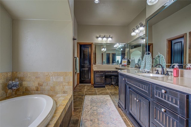 bathroom featuring vanity and a bath