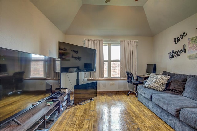 living area featuring hardwood / wood-style flooring, lofted ceiling, a desk, and ceiling fan