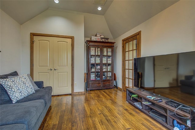 living area featuring wood finished floors and vaulted ceiling