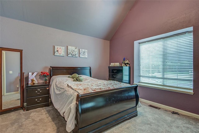 bedroom with lofted ceiling and light colored carpet