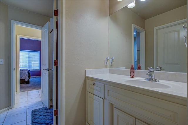 bathroom featuring vanity, tile patterned flooring, and a textured wall