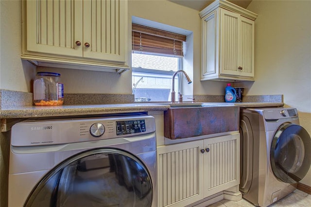 washroom with washer and clothes dryer and cabinet space