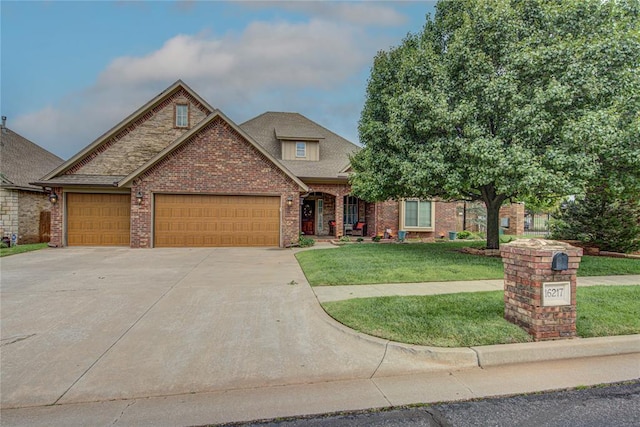 view of front facade featuring brick siding, an attached garage, a front yard, and driveway