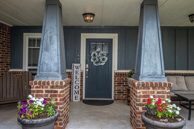 4450 Buffalo Hl, Guthrie, OK 73044 - view of exterior entry with covered porch, board and batten siding, brick siding, and radiator