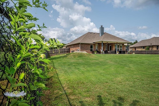 4450 Buffalo Hl, Guthrie, OK 73044 - rear view of property with a fenced backyard, brick siding, a chimney, a ceiling fan, and roof with shingles