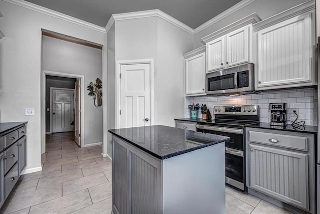 4450 Buffalo Hl, Guthrie, OK 73044 - kitchen with stainless steel appliances, a kitchen island, backsplash, dark stone countertops, and light tile patterned floors