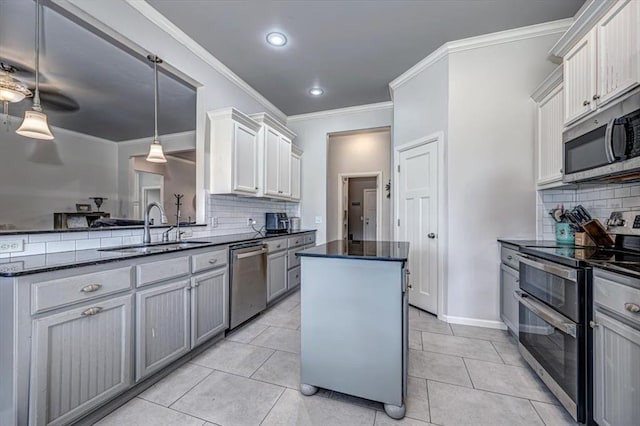 4450 Buffalo Hl, Guthrie, OK 73044 - kitchen with stainless steel appliances, a kitchen island, tasteful backsplash, dark stone countertops, and recessed lighting