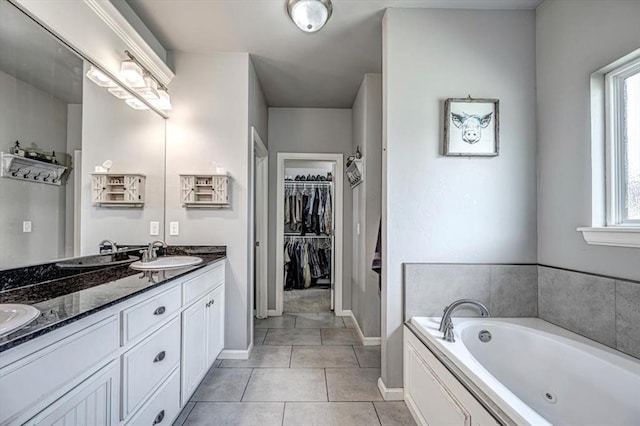 4450 Buffalo Hl, Guthrie, OK 73044 - bathroom with double vanity, a whirlpool tub, tile patterned flooring, and a spacious closet