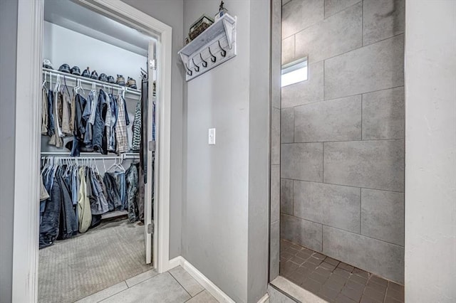 4450 Buffalo Hl, Guthrie, OK 73044 - bathroom with tile patterned floors, a tile shower, and a walk in closet