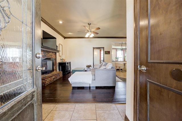 1106 Polk St, Piedmont, OK 73078 - living room with crown molding, a fireplace, light tile patterned floors, and a ceiling fan