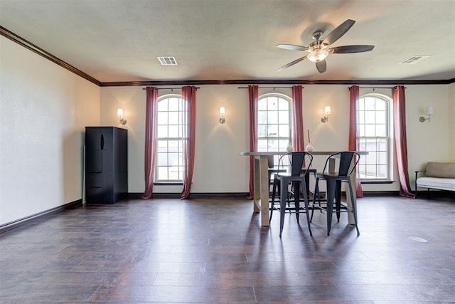 1106 Polk St, Piedmont, OK 73078 - dining space featuring crown molding, dark wood finished floors, a ceiling fan, and healthy amount of natural light