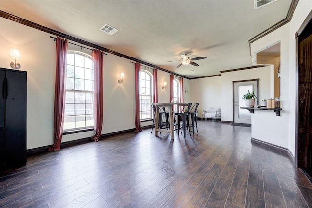 1106 Polk St, Piedmont, OK 73078 - dining space featuring ornamental molding, a ceiling fan, and dark wood-type flooring