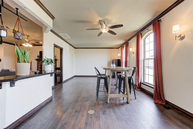 1106 Polk St, Piedmont, OK 73078 - dining space with ceiling fan, ornamental molding, dark wood finished floors, and plenty of natural light