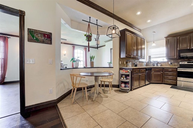 1106 Polk St, Piedmont, OK 73078 - kitchen with stainless steel appliances, tasteful backsplash, dark brown cabinetry, recessed lighting, and hanging light fixtures