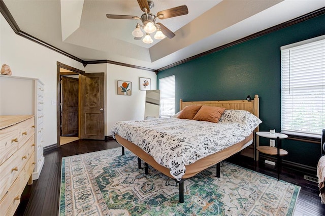 1106 Polk St, Piedmont, OK 73078 - bedroom with multiple windows, a tray ceiling, crown molding, and dark wood-type flooring