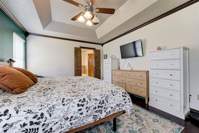 1106 Polk St, Piedmont, OK 73078 - bedroom with dark wood finished floors, a tray ceiling, ornamental molding, and ceiling fan