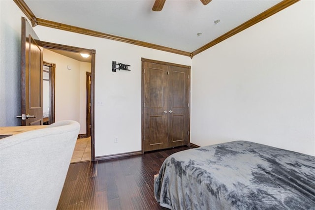 1106 Polk St, Piedmont, OK 73078 - bedroom featuring crown molding, dark wood-style flooring, a ceiling fan, and a closet