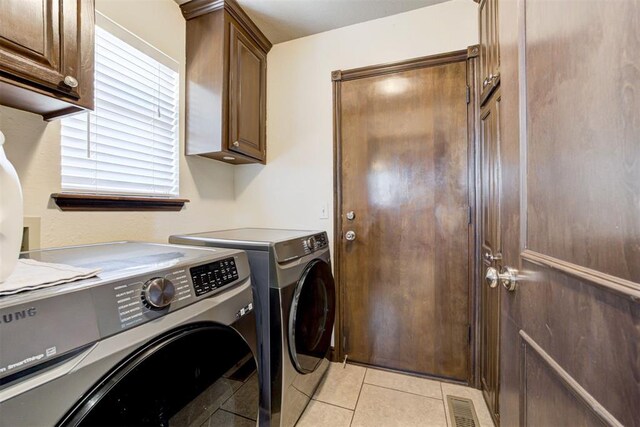 1106 Polk St, Piedmont, OK 73078 - laundry room with cabinet space, independent washer and dryer, and light tile patterned flooring