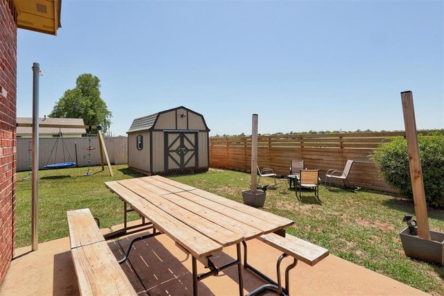 1106 Polk St, Piedmont, OK 73078 - fenced backyard with outdoor dining area, a storage unit, and a patio area