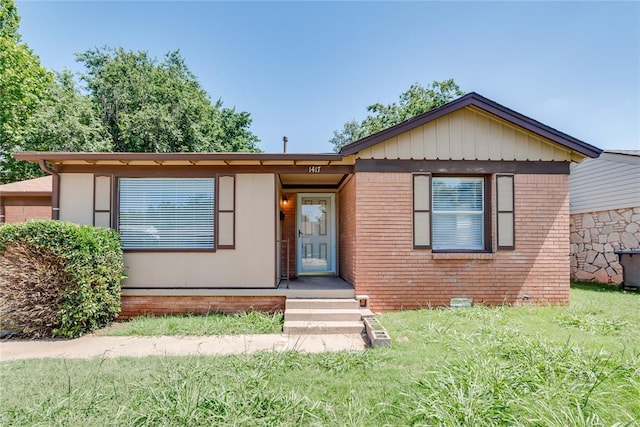 1417 Downing St, The Village, OK 73120 - view of front of house with a front lawn and brick siding