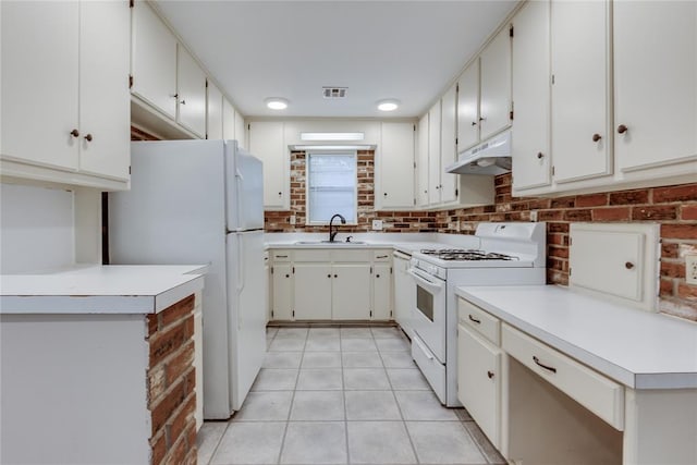 1417 Downing St, The Village, OK 73120 - kitchen featuring white appliances, under cabinet range hood, light tile patterned floors, light countertops, and tasteful backsplash