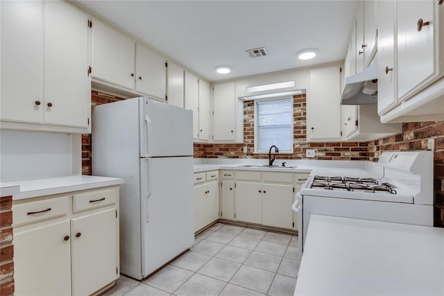 1417 Downing St, The Village, OK 73120 - kitchen featuring white appliances, under cabinet range hood, light countertops, and light tile patterned floors