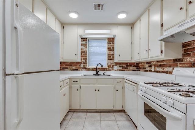 1417 Downing St, The Village, OK 73120 - kitchen featuring white appliances, under cabinet range hood, light tile patterned floors, light countertops, and tasteful backsplash