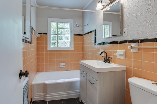 1417 Downing St, The Village, OK 73120 - full bath featuring vanity, shower / tub combination, tile walls, tile patterned flooring, and wainscoting