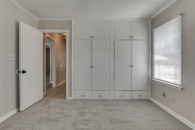 1417 Downing St, The Village, OK 73120 - unfurnished bedroom featuring light colored carpet, ornamental molding, and a closet