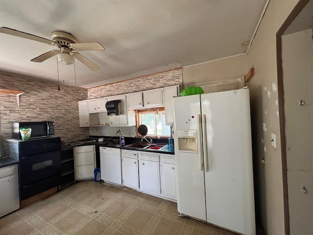 1139 E 2nd St, Cushing, OK 74023 - kitchen with white appliances, dark countertops, white cabinets, and a ceiling fan