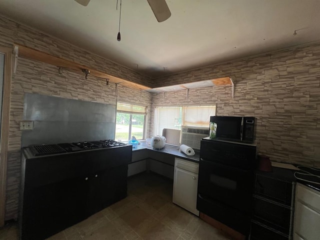 1139 E 2nd St, Cushing, OK 74023 - kitchen with black appliances, dark countertops, a ceiling fan, a desk, and cooling unit