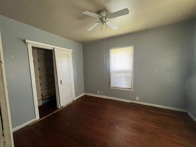 1139 E 2nd St, Cushing, OK 74023 - unfurnished bedroom with wood finished floors, a closet, and ceiling fan