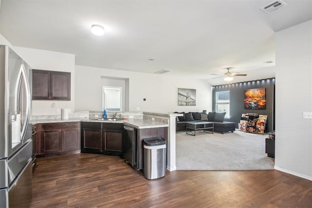 11712 NW 130th St, Piedmont, OK 73078 - kitchen with stainless steel appliances, a peninsula, open floor plan, dark brown cabinetry, and light stone counters