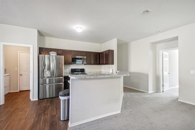 11712 NW 130th St, Piedmont, OK 73078 - kitchen featuring stainless steel appliances, dark brown cabinetry, washer / clothes dryer, and light stone counters