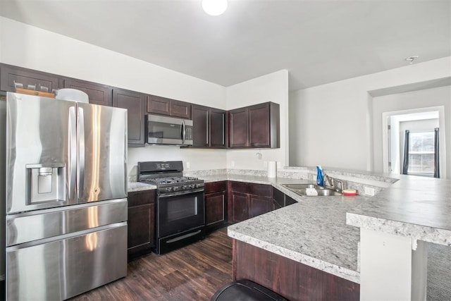 11712 NW 130th St, Piedmont, OK 73078 - kitchen featuring stainless steel appliances, a peninsula, light countertops, dark wood finished floors, and dark brown cabinetry