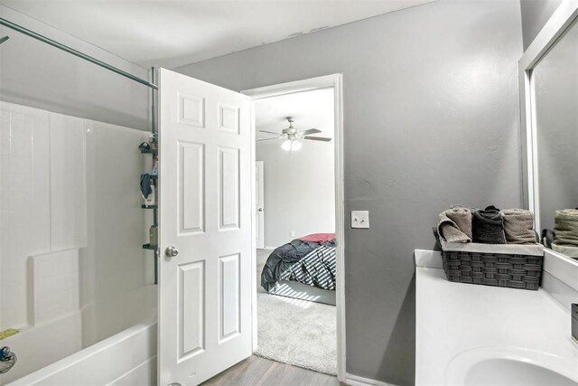 11712 NW 130th St, Piedmont, OK 73078 - ensuite bathroom featuring wood finished floors, ceiling fan, bathing tub / shower combination, and vanity