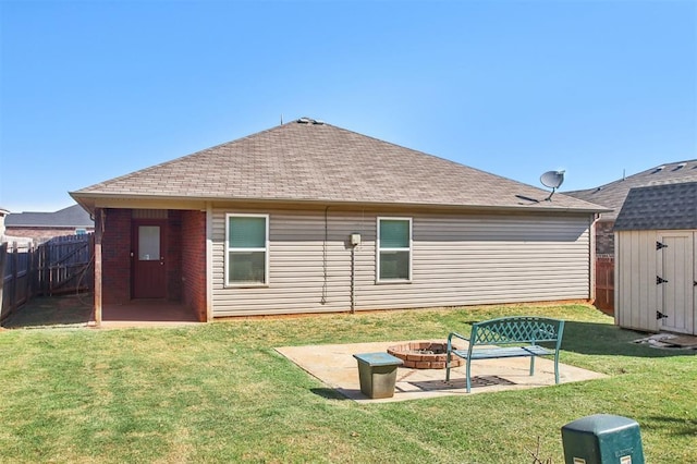 11712 NW 130th St, Piedmont, OK 73078 - back of house featuring an outdoor fire pit, a shed, a patio area, a fenced backyard, and roof with shingles