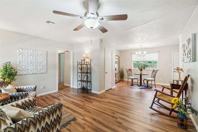 1726 Caddell Ln, Norman, OK 73069 - living area with a chandelier, ceiling fan, and wood finished floors