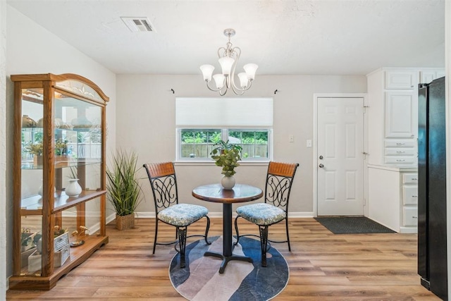 1726 Caddell Ln, Norman, OK 73069 - dining space with a chandelier and light wood-type flooring