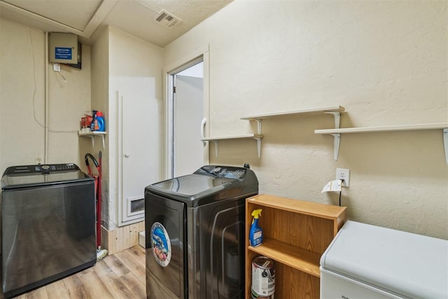 1726 Caddell Ln, Norman, OK 73069 - laundry area with washer and dryer and light wood-style floors