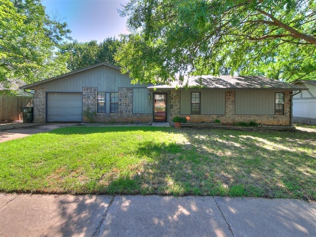 1916 Twin Tree Dr, Norman, OK 73071 - view of front of property featuring stone siding, an attached garage, and driveway