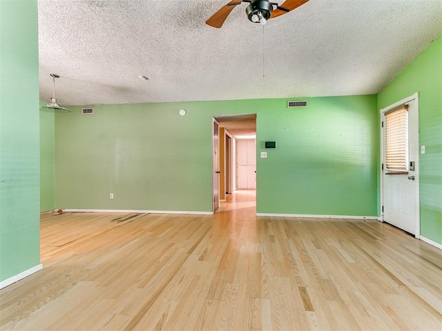 1916 Twin Tree Dr, Norman, OK 73071 - empty room with a ceiling fan, wood finished floors, and a textured ceiling
