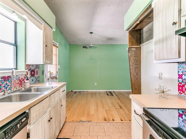 1916 Twin Tree Dr, Norman, OK 73071 - kitchen with dishwasher, a textured ceiling, light countertops, light tile patterned flooring, and light brown cabinets